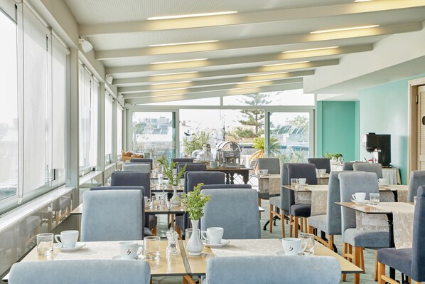 A modern cafe with tables and chairs arranged for dining.