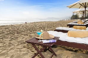 On the beach, white sand, sun-loungers, beach umbrellas - TTC Hotel - Michelia (Nha Trang)