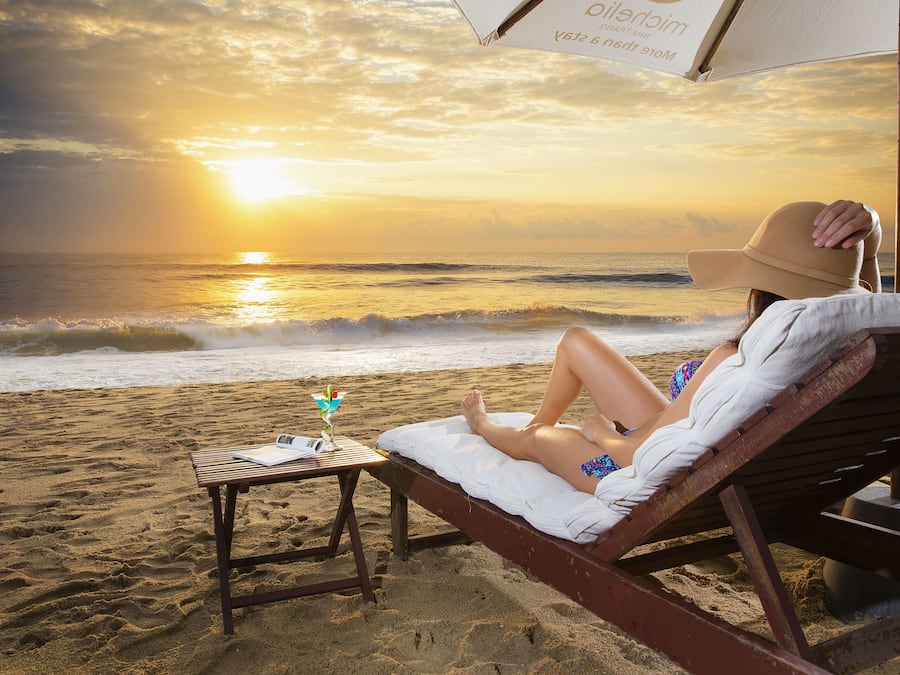 On the beach, white sand, sun loungers, beach umbrellas
