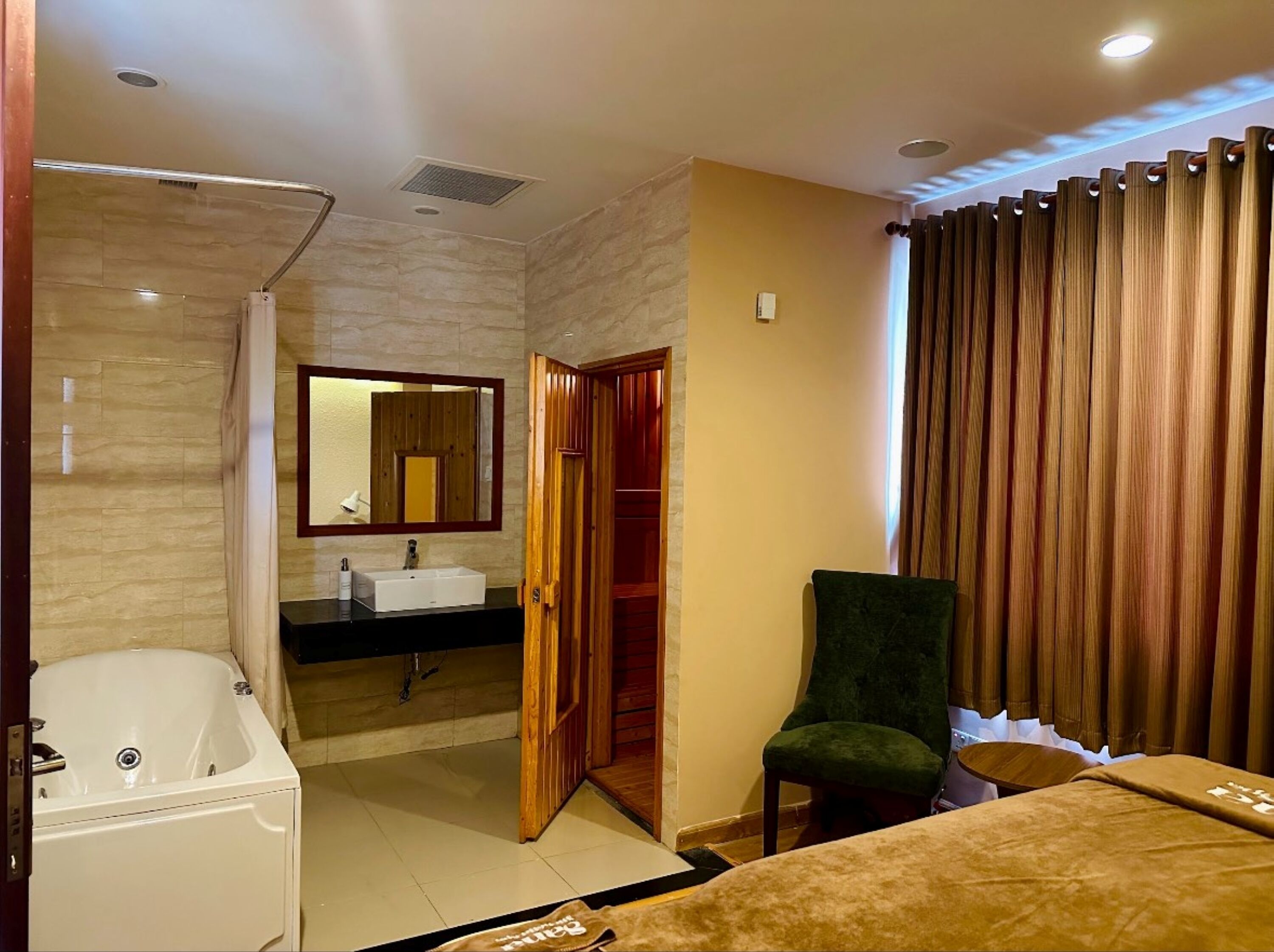 A modern bathroom with a bathtub, sink, and mirror.
