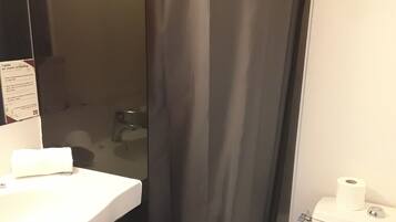 A bathroom with a bathtub, a toilet, and a sink.