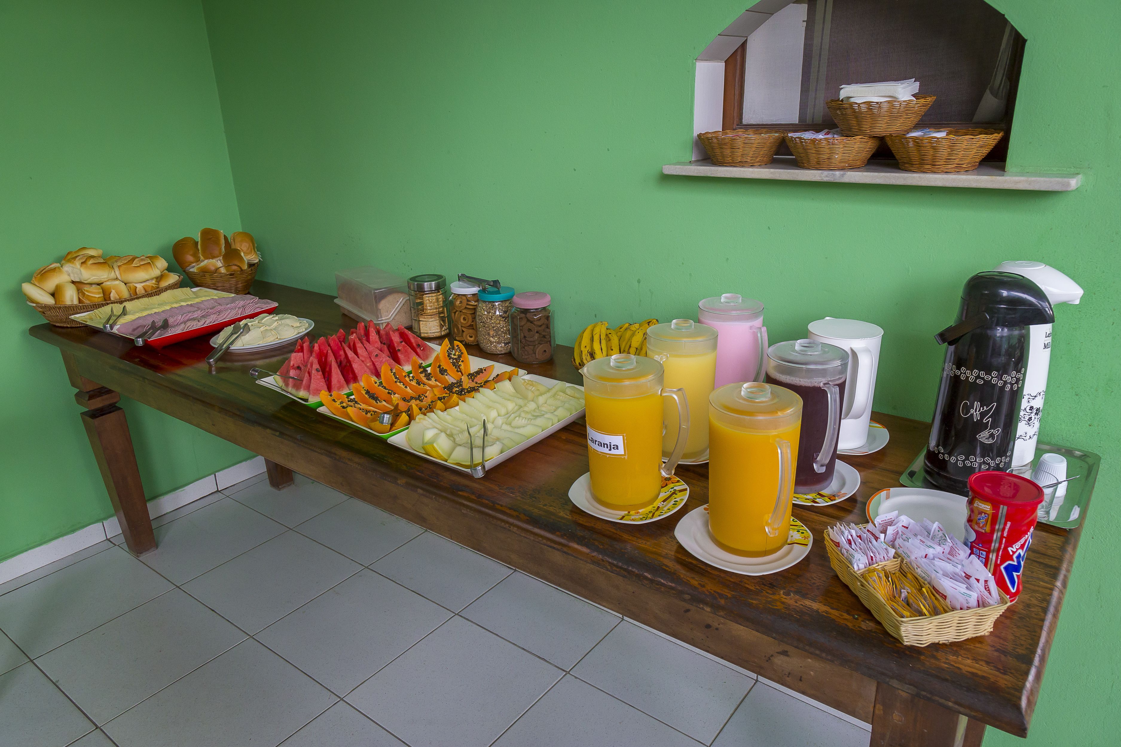 A buffet table with various food items and beverages.
