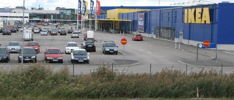 A busy road with multiple lanes and traffic signs, including a no entry sign and a roundabout.