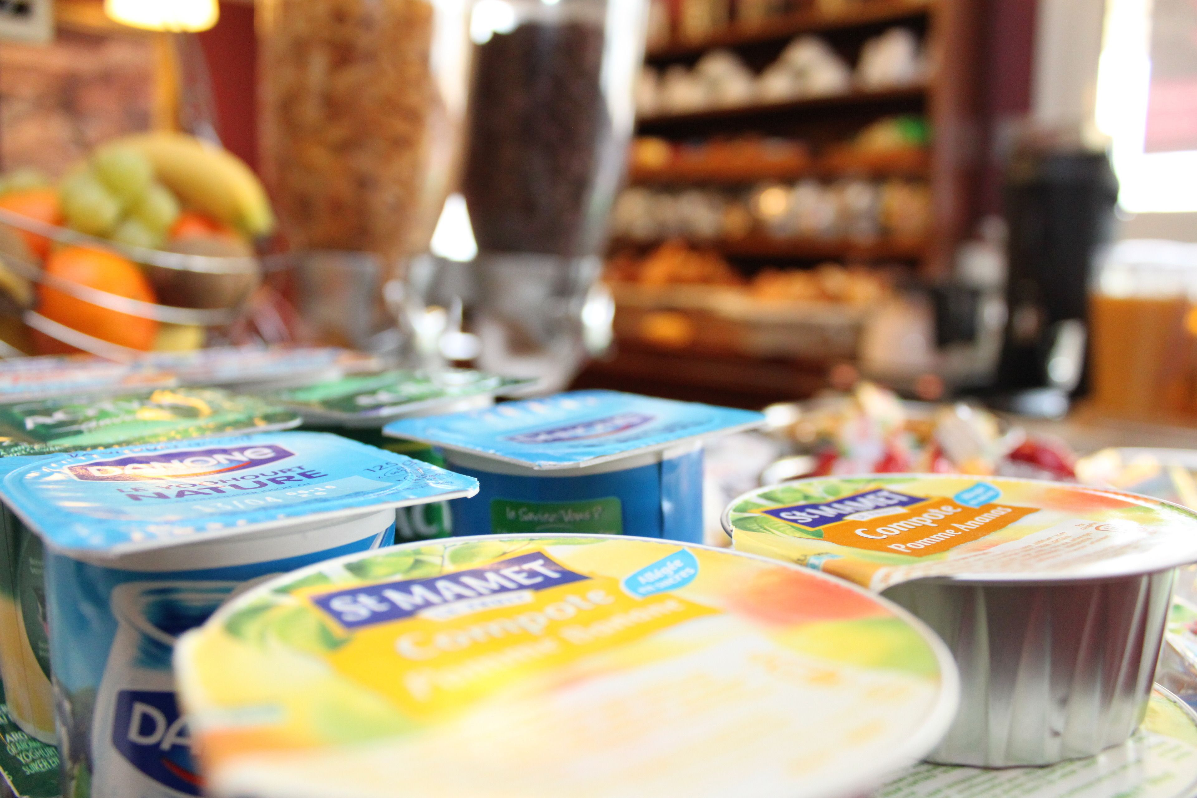 A selection of yogurt containers on display in a store.