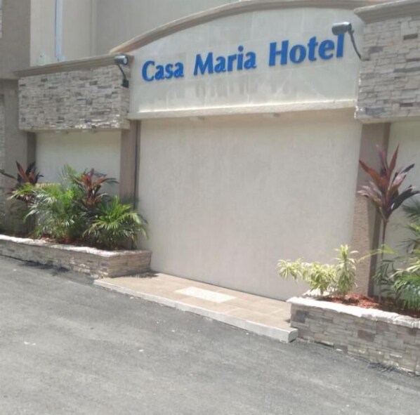 Experience the simplicity of Casa Maria Hotel's modern design, featuring a stone facade and a flat roof.