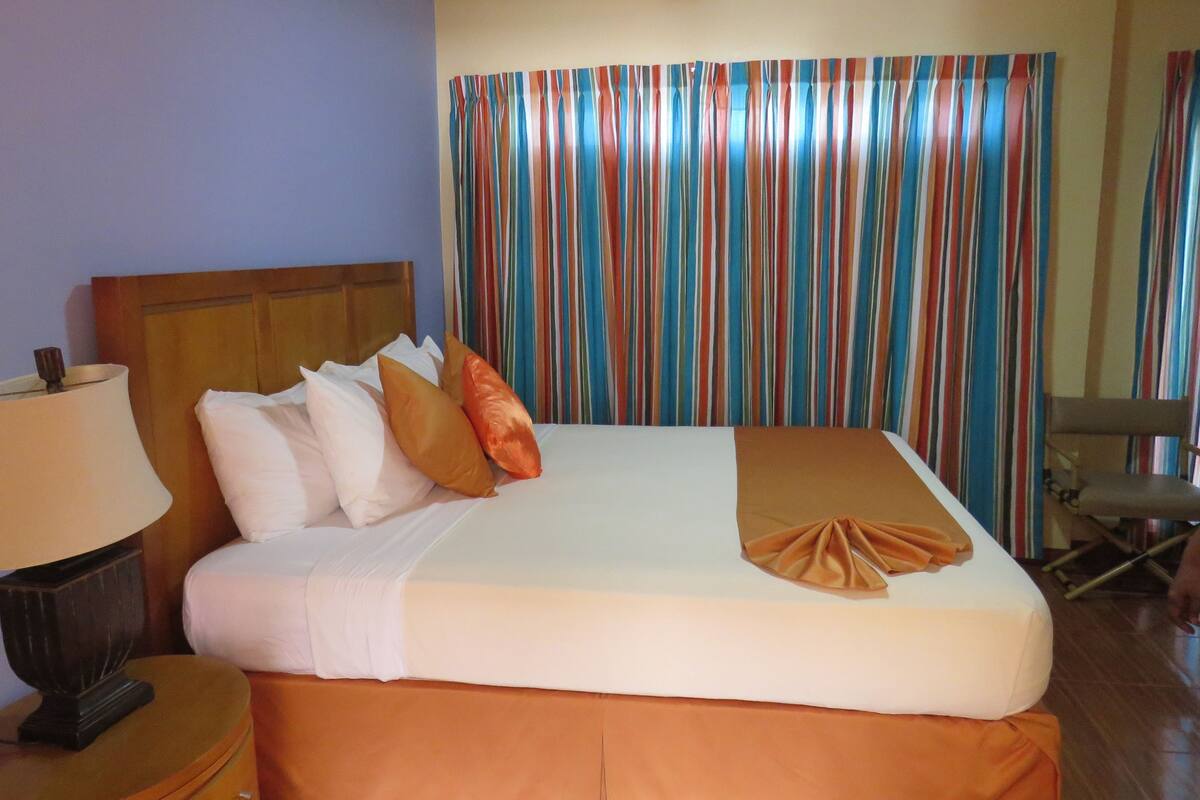 Premium bedding, desk, laptop workspace, blackout curtains