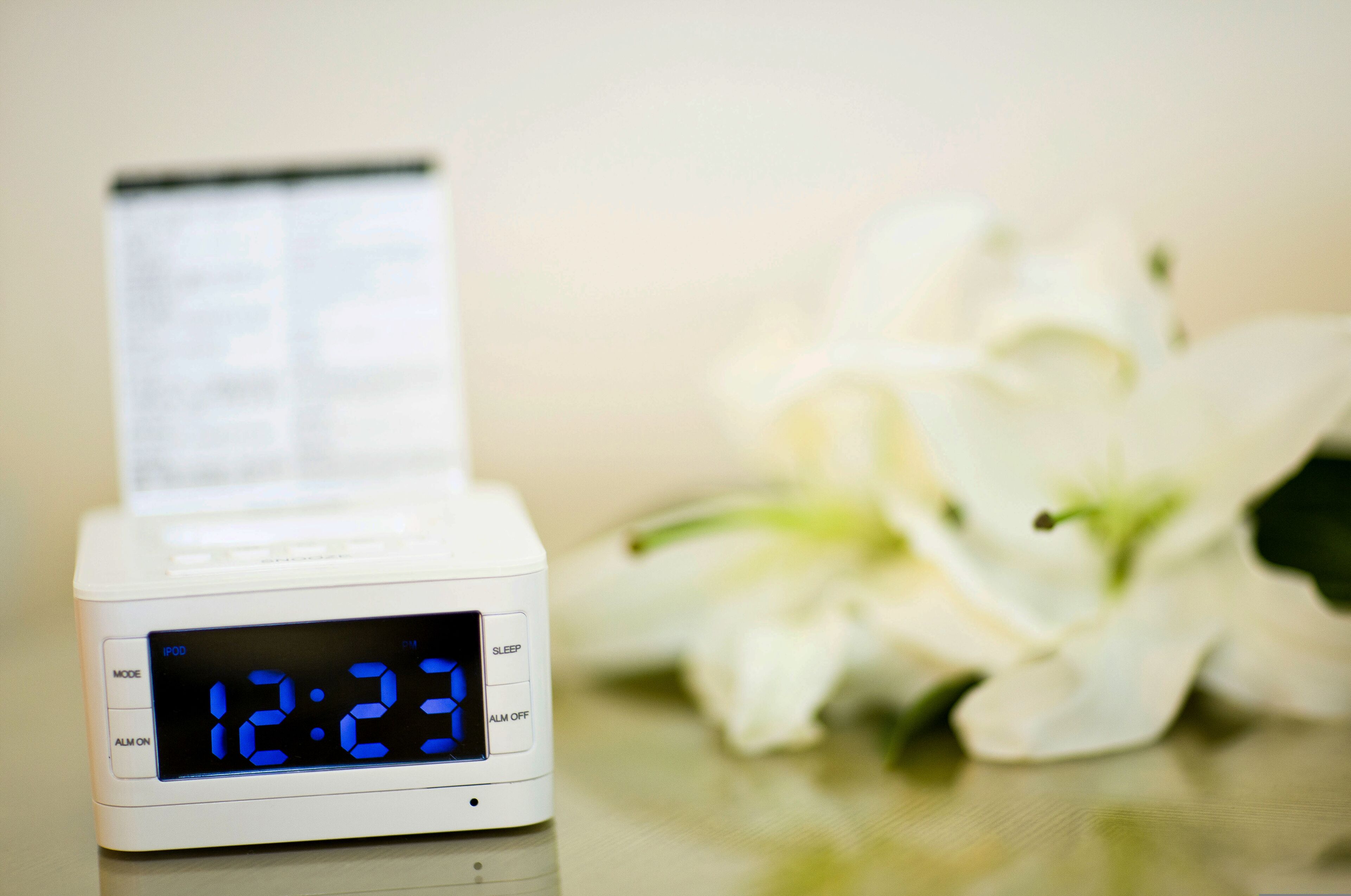 A digital clock displaying 12:23, with a menu button and sleep mode option.