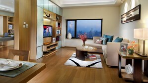 A modern living room with a dining area, a large window with a city view, and a cozy seating arrangement. - Somerset International Building Tianjin (Tianjin)