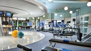 A modern gym with cardio equipment, weight machines, and exercise balls. - Somerset International Building Tianjin (Tianjin)