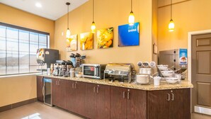 A hotel kitchen with a granite countertop, a coffee machine, a microwave, a toaster, and a refrigerator. - Comfort Inn & Suites Mojave (Mojave)