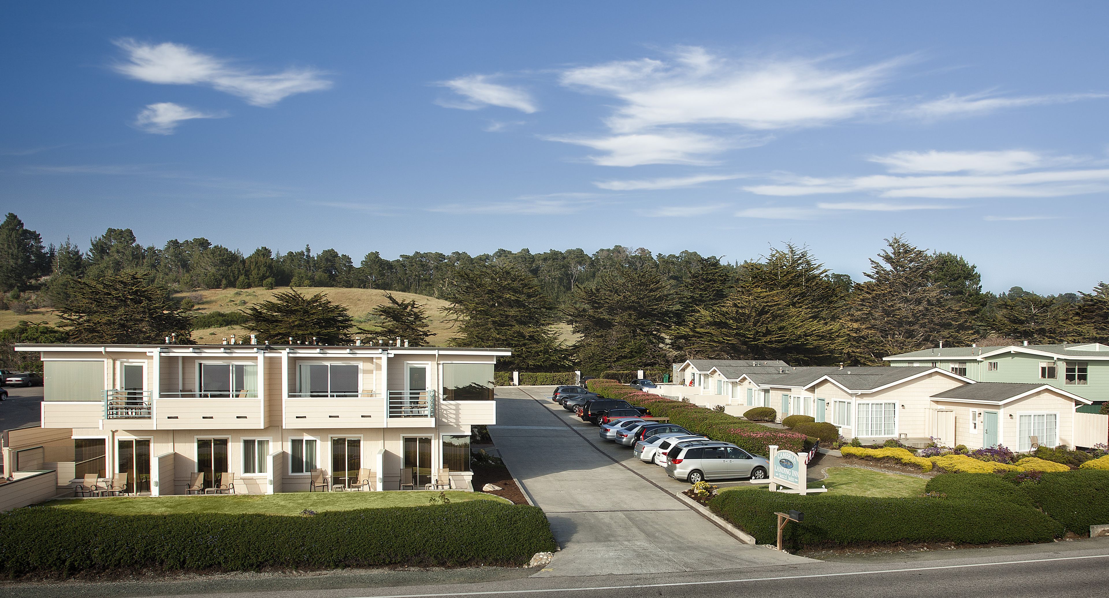 A row of modern, two-story mobile homes with a parking lot in front.