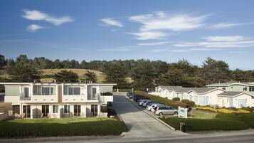 A row of modern, two-story mobile homes with a parking lot in front.