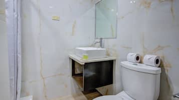 A modern bathroom with a marble floor, a white sink, and a toilet.