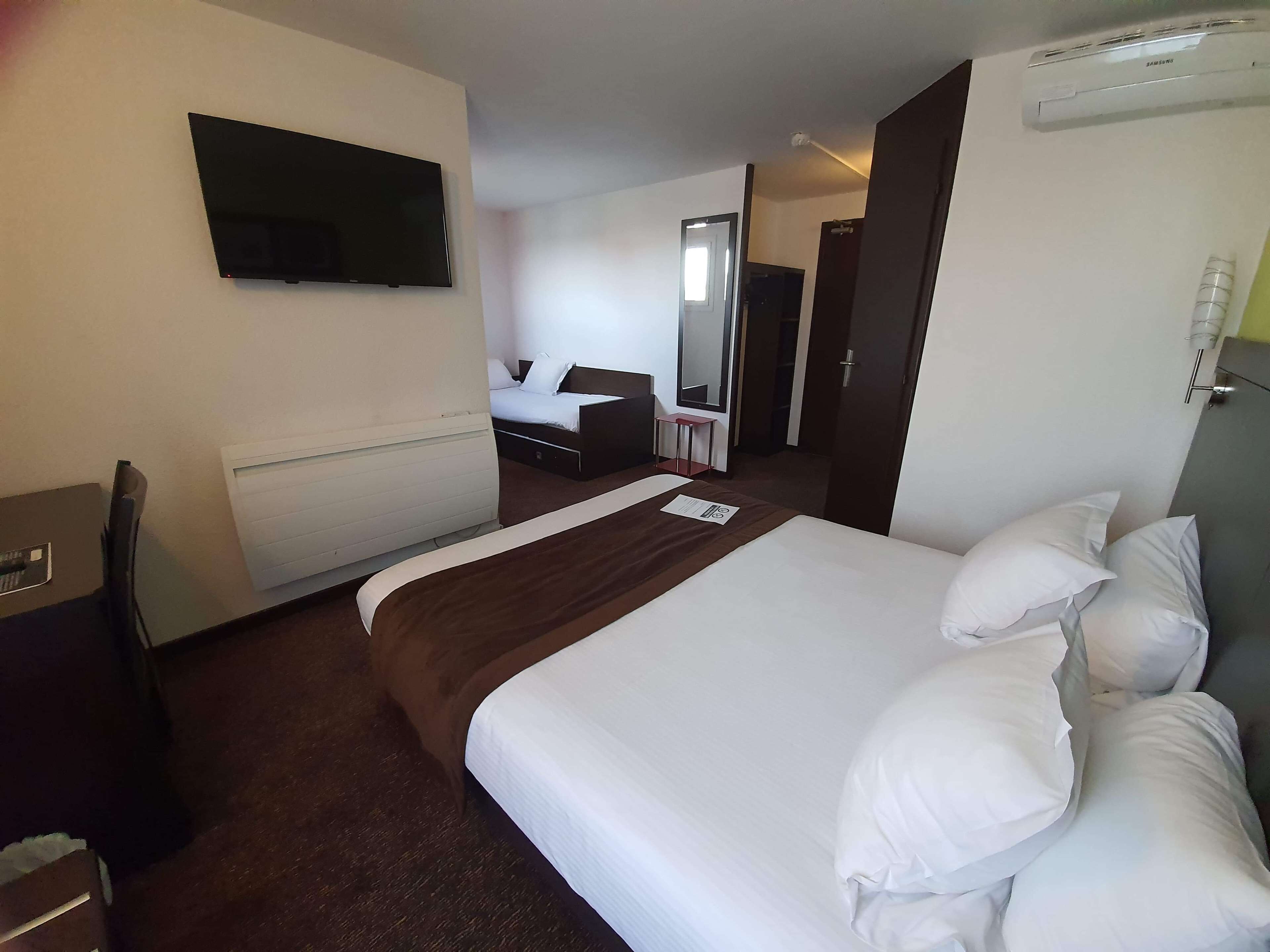 memory-foam beds, desk, laptop workspace, blackout curtains