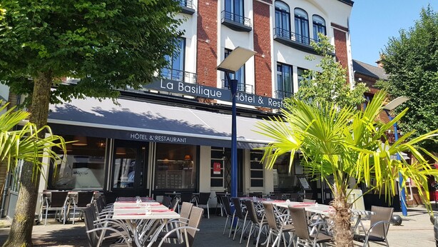 A hotel named "La Basilique" with outdoor seating and a brick facade. - Hotel & Restaurant de la Basilique (Albert)