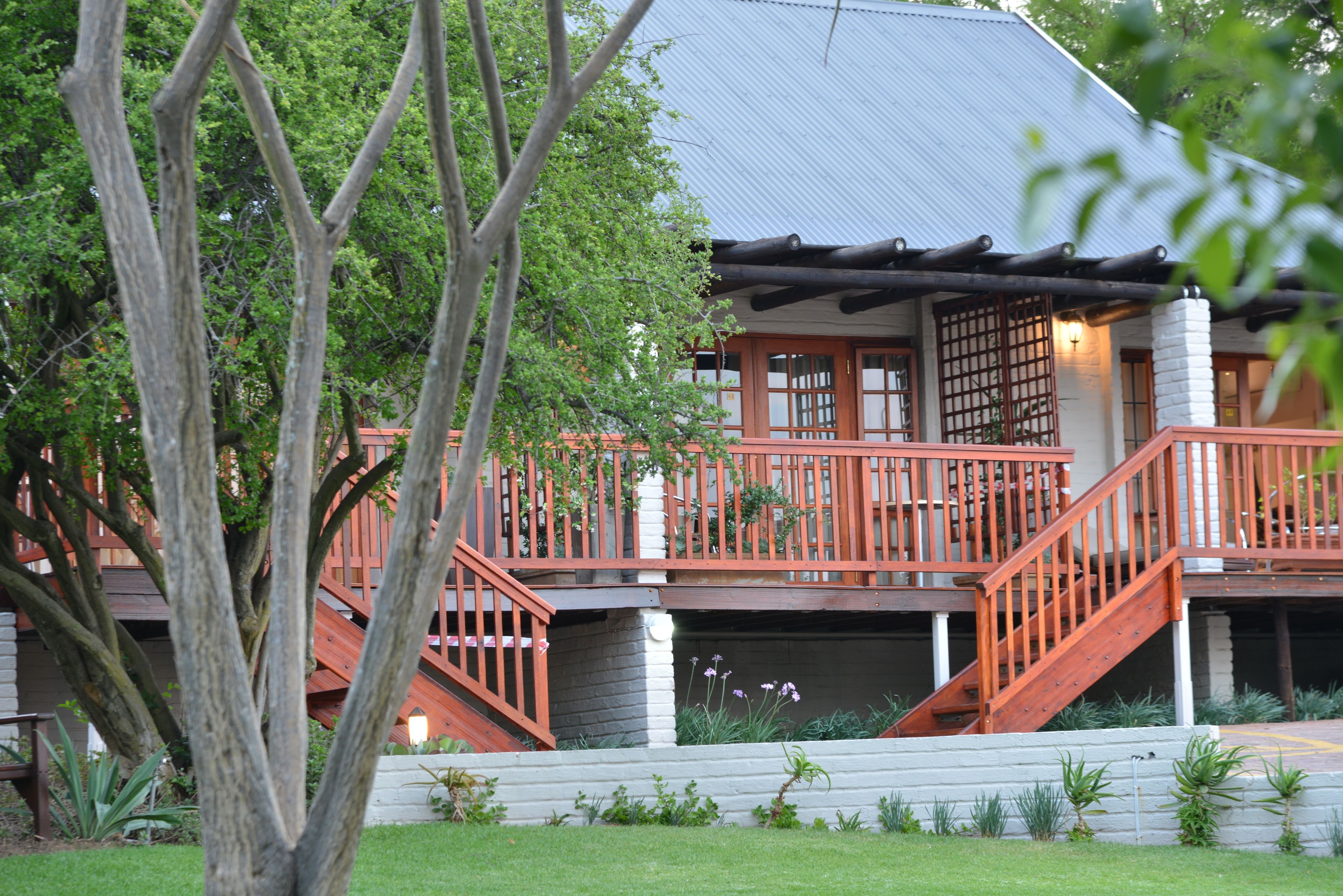 A traditional Japanese-style building with a wooden deck and a covered entrance.