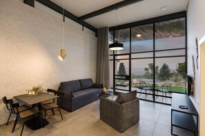 Deluxe Suite, 1 Bedroom | Living area | 32-inch LCD TV with cable channels, TV