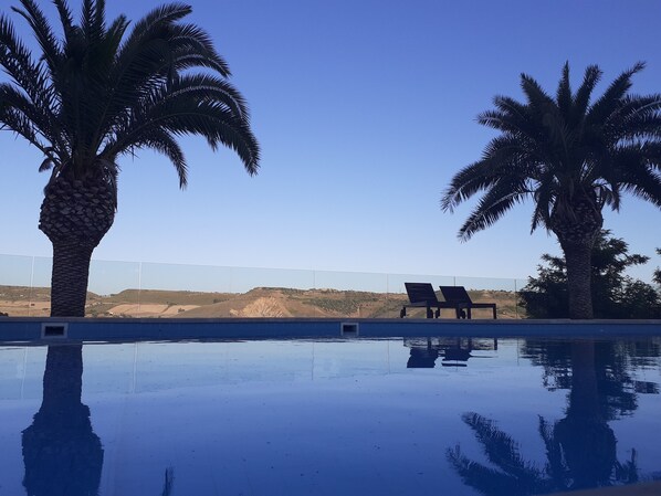 Seasonal outdoor pool, open 10:30 AM to 6:00 PM, pool loungers