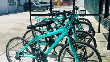 A covered bike parking area with several bicycles.