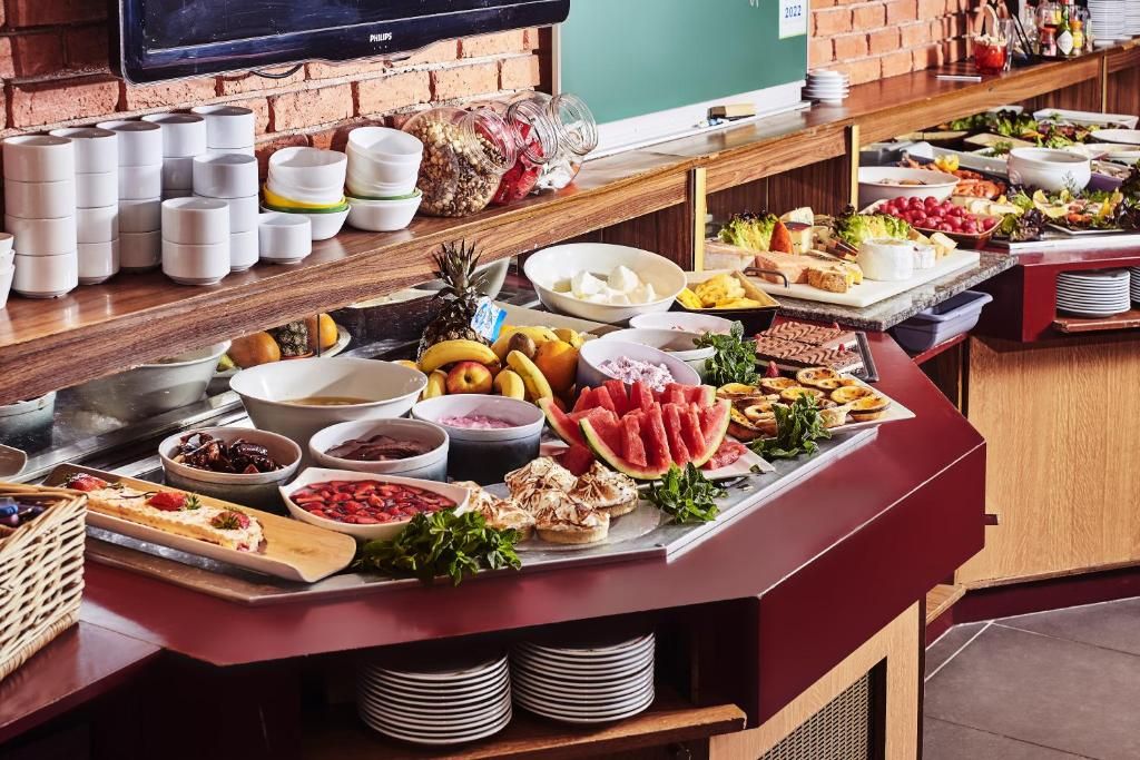 A buffet with various food items and condiments.