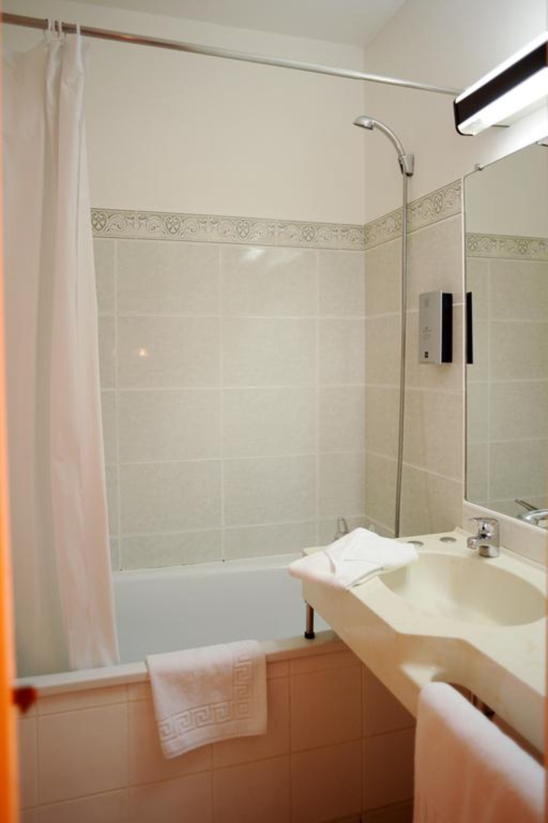 A bathroom with a shower, a bathtub, a sink, and a mirror.