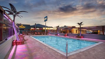 Seasonal outdoor pool, open 9:00 AM to 10:00 PM, pool umbrellas