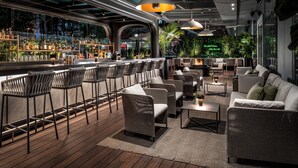 A modern bar area with seating and a bar counter. - The Ritz-Carlton, Toronto (Toronto)