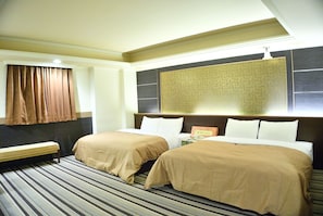 A hotel room with two beds, a bench, and a large wall decoration.