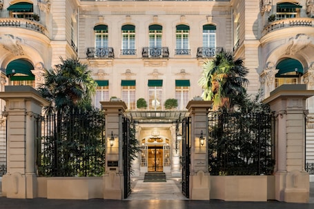 A grand entrance with a double door, a staircase, and a balcony with railings.