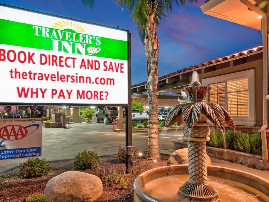 A Traveler's Inn sign with a direct booking option and a AAA Approved Lodging badge.