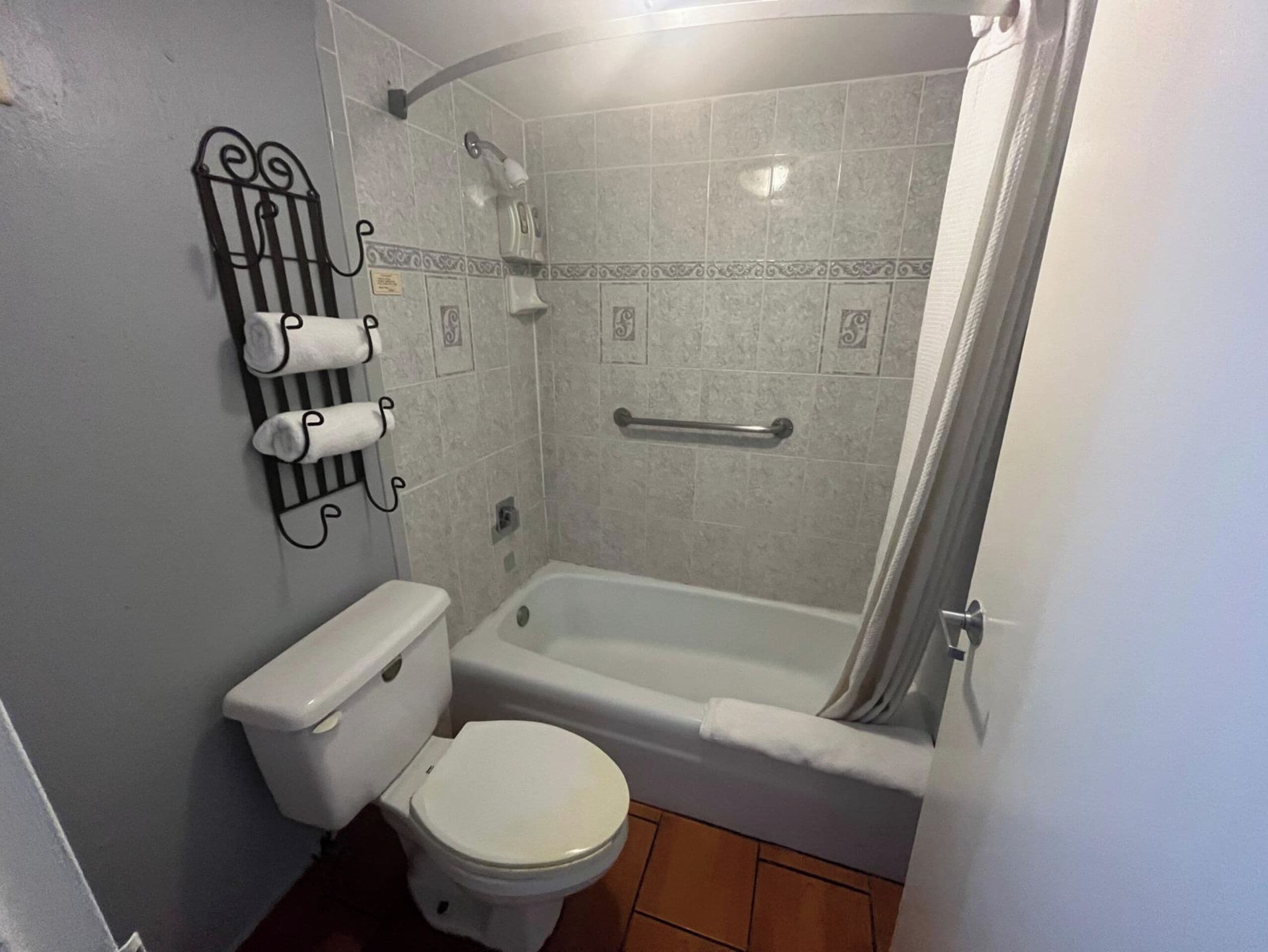 A bathroom with a toilet, a shower, and a bathtub.