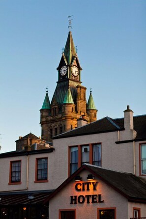 A hotel with a prominent clock tower and a sign reading "CITY HOTEL" on the facade. - The City Hotel (Dunfermline)