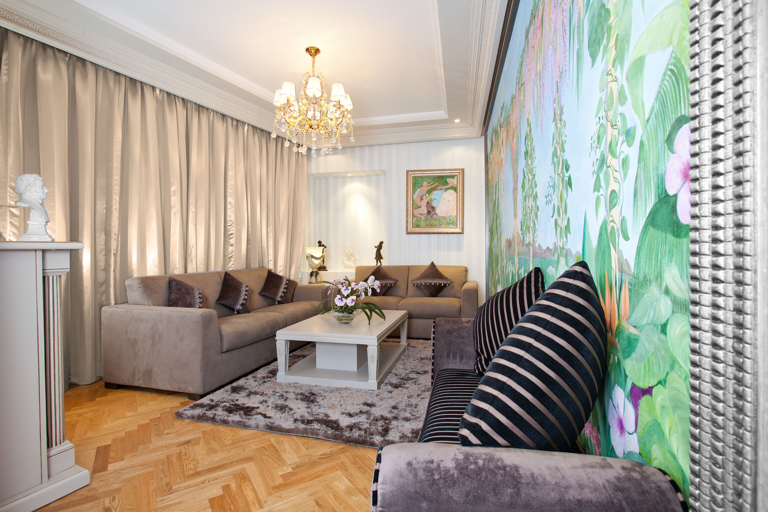 A living room with a sofa, a coffee table, and a chandelier.