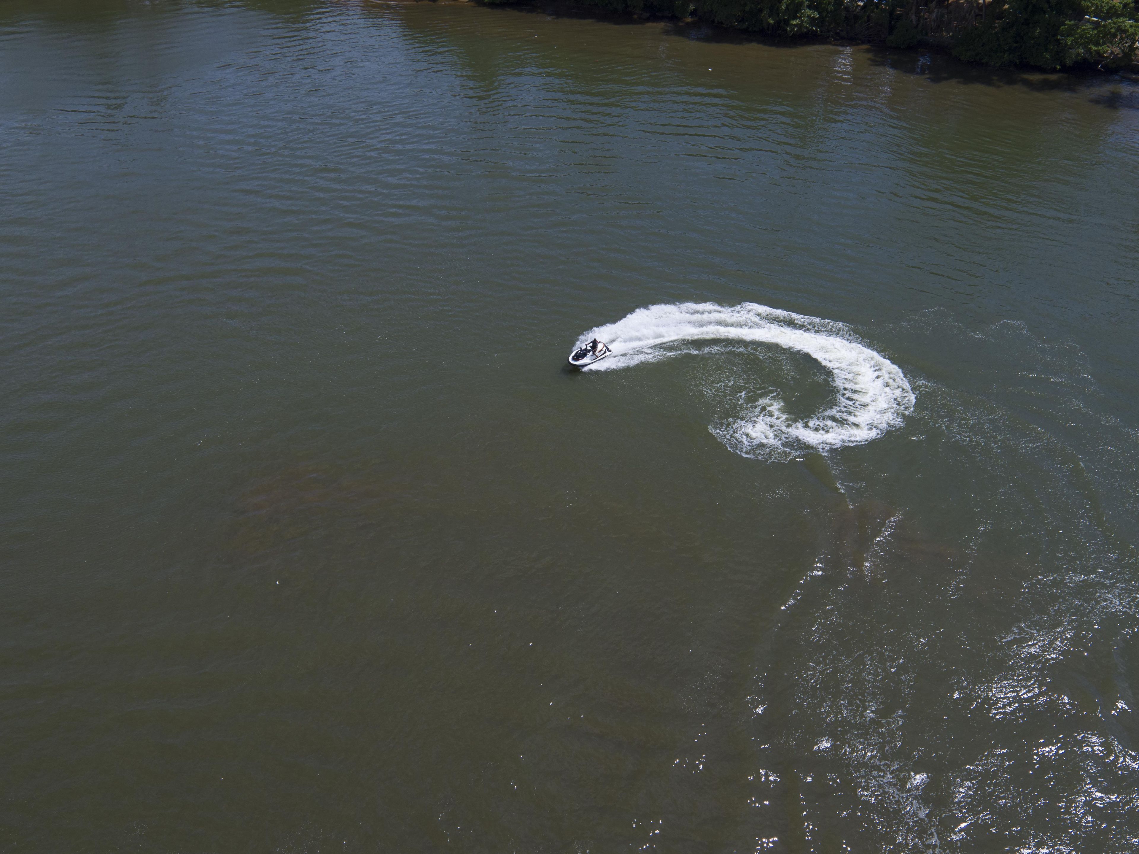 A body of water with a wake pattern indicating movement.