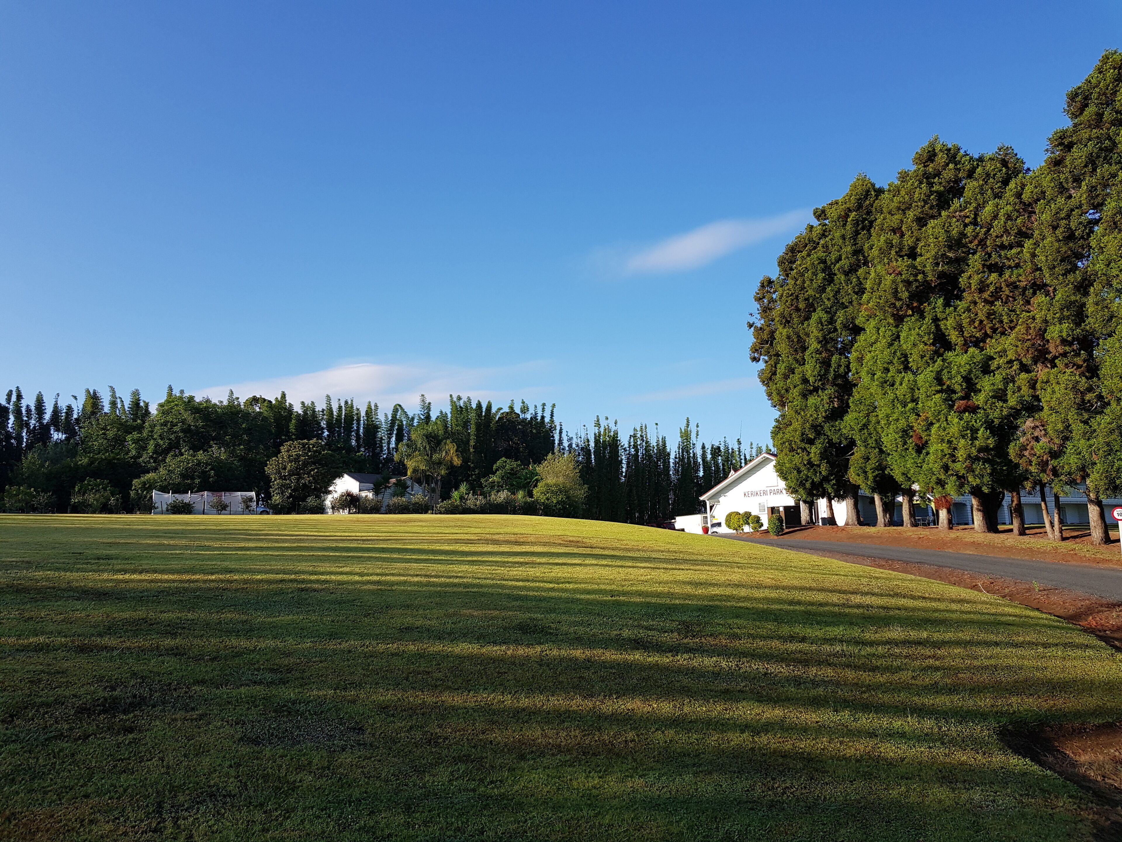 A large grassy field with a building labeled "KERIKERI PARK" and a row of trees.
