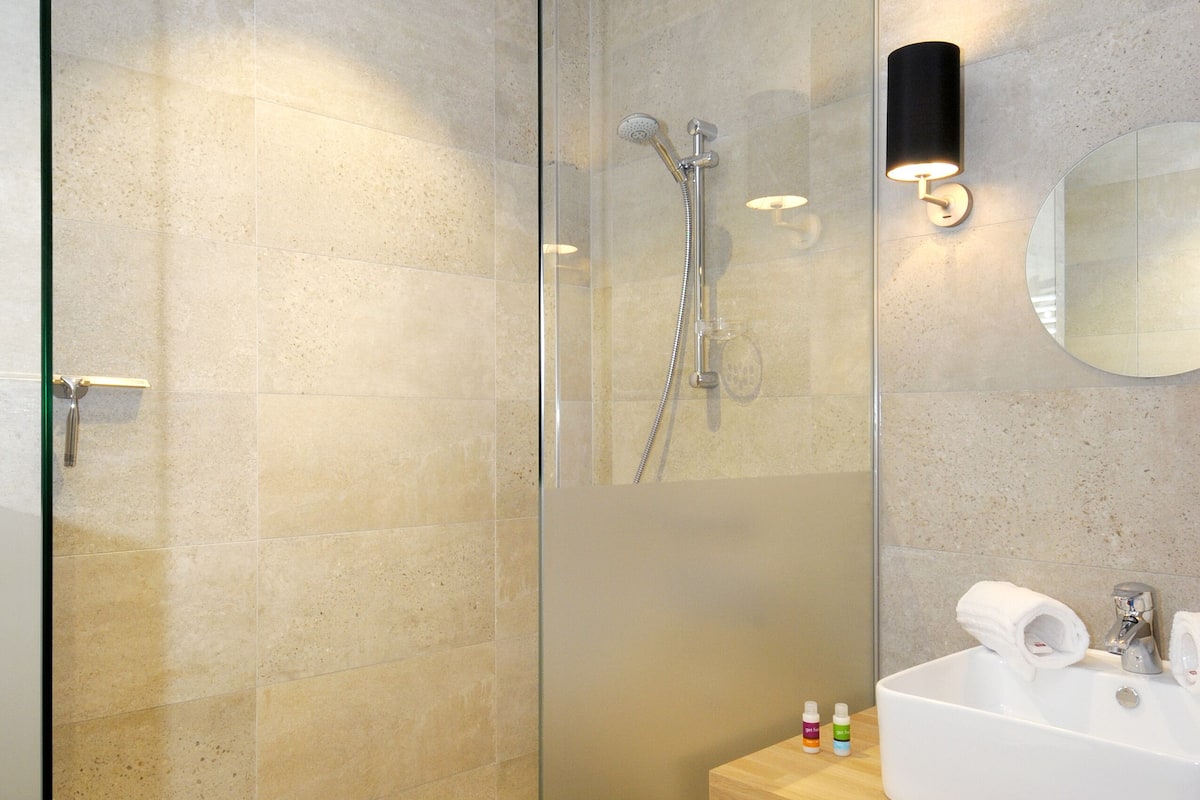 separate bathtub and shower, hair dryer, towels, soap