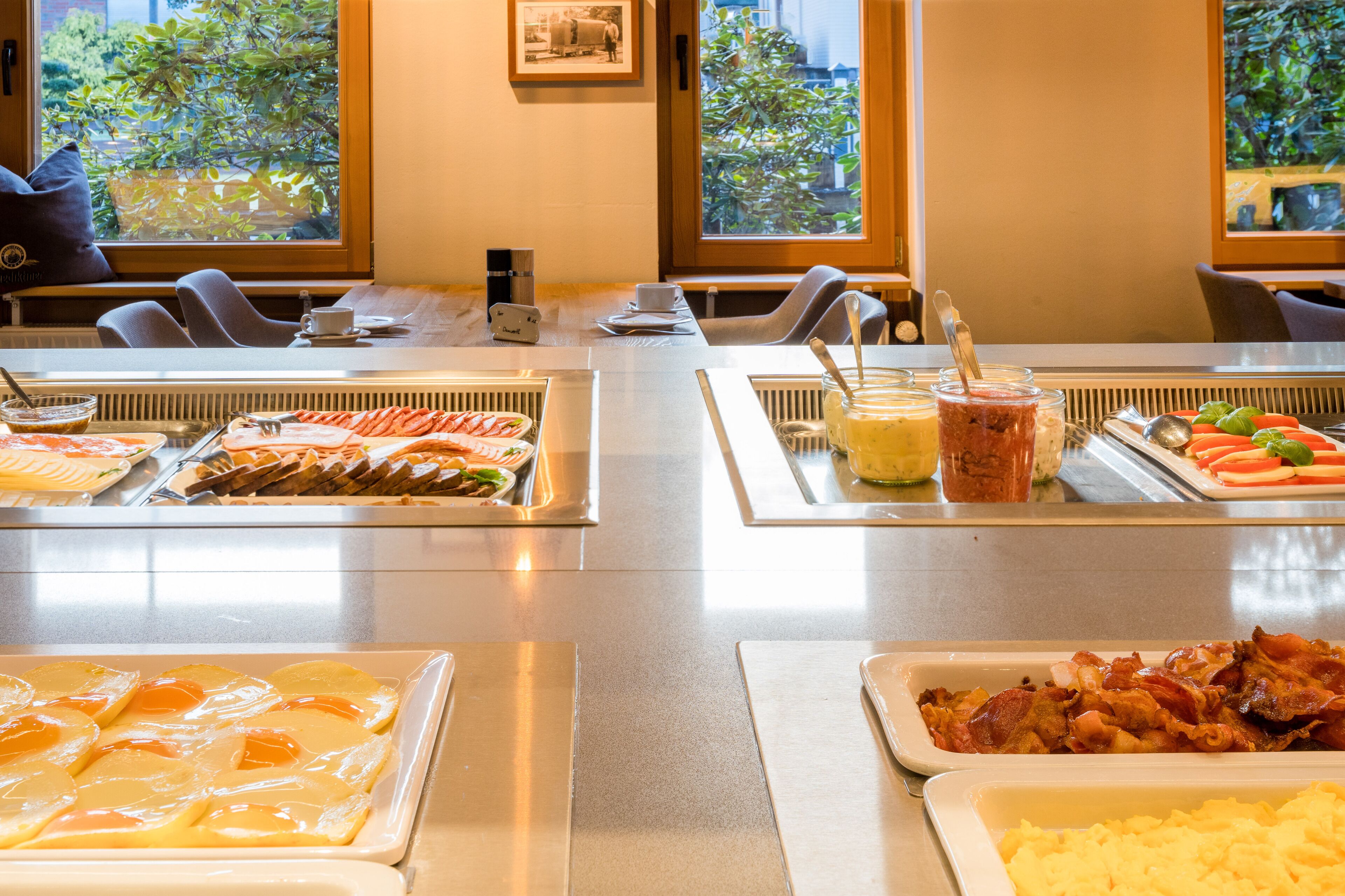 A buffet setup with various food items and a coffee station.