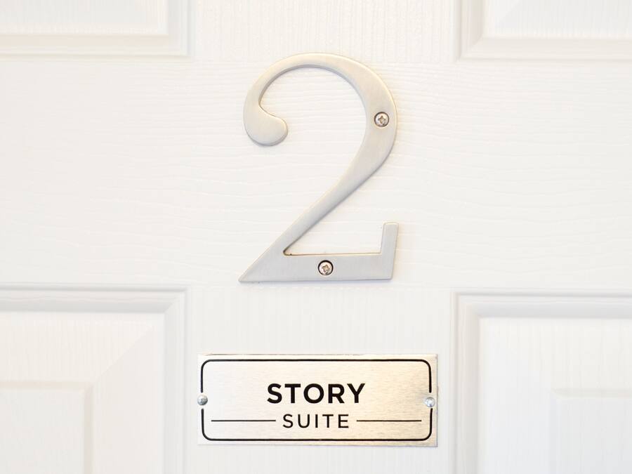 A door with a number 2 sign and a label reading "STORY SUITE".