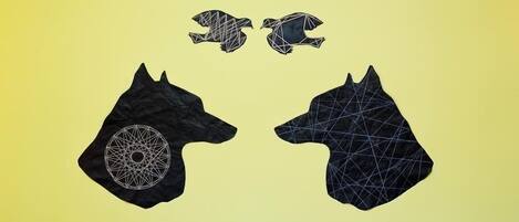 Two black geometric horse-shaped rugs with a circular pattern on one side, set against a yellow background.