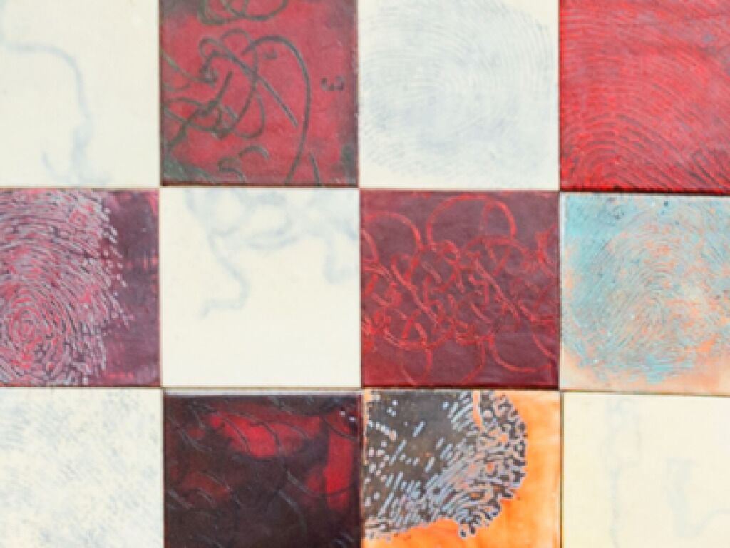 A tiled wall with various patterns and textures.