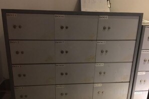 A metal storage unit with multiple compartments, each labeled with a unique identifier. - Century Palace Hotel (Huizhou)