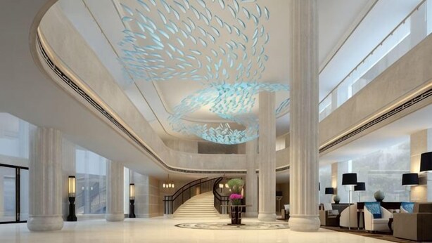 A spacious lobby with a large central staircase, high ceilings, and modern lighting fixtures. - Century Palace Hotel (Huizhou)