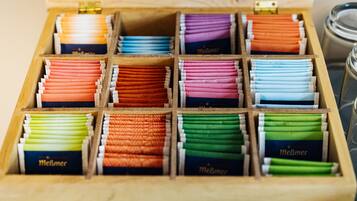 A wooden box with compartments containing various colored cigarette packs.