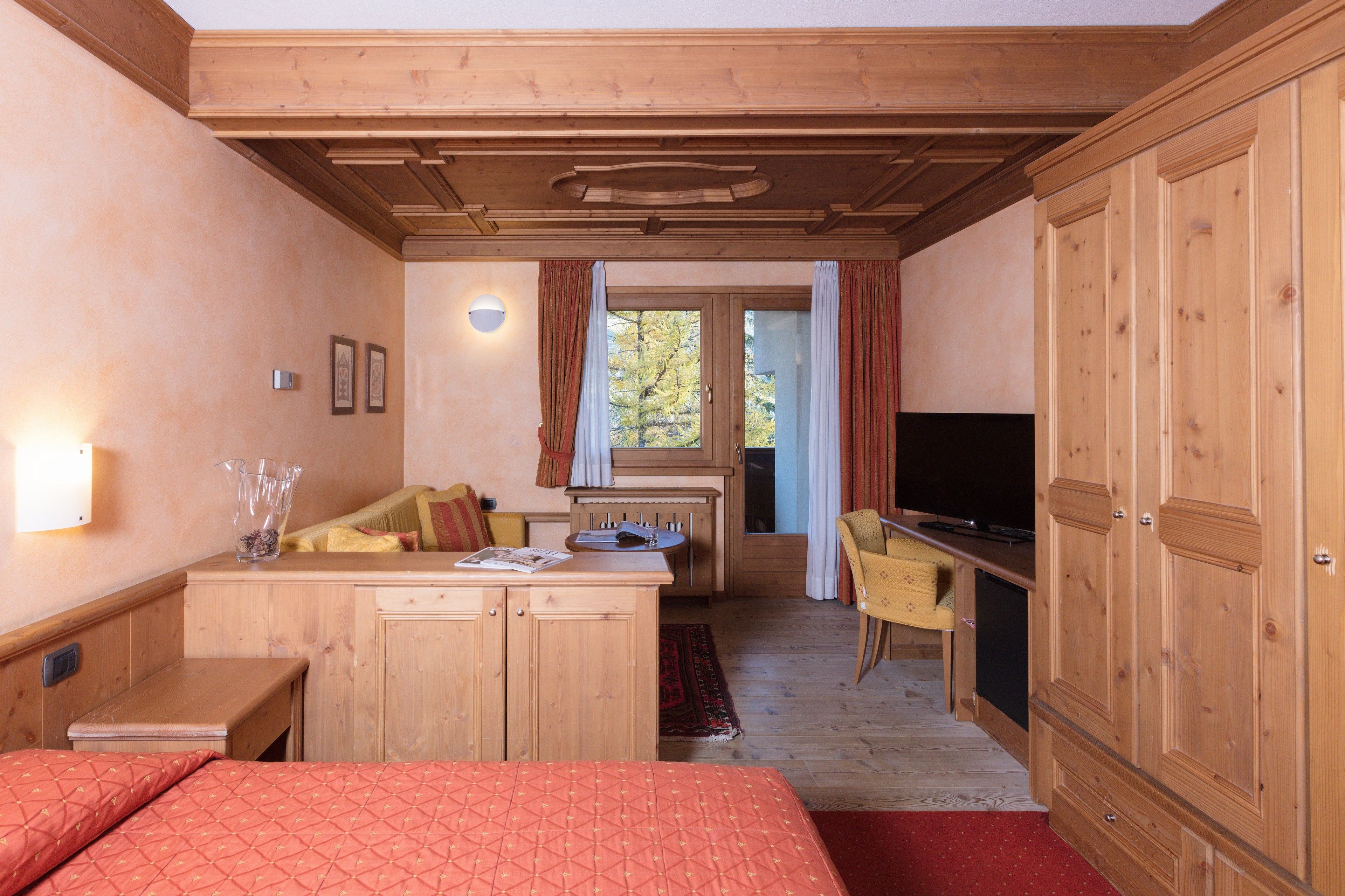 deluxe quadruple room | minibar, in-room safe, desk, blackout curtains