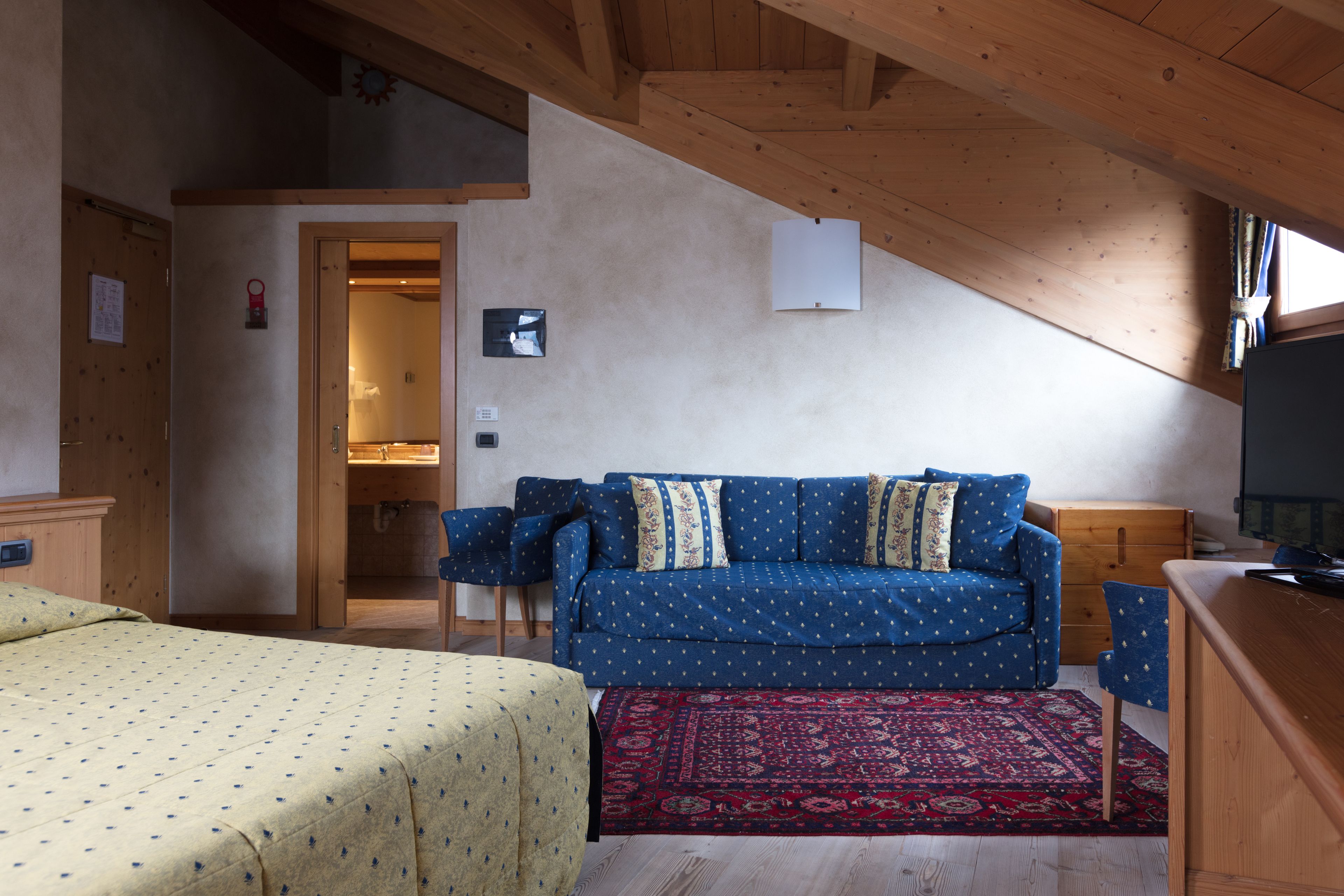 deluxe quadruple room | minibar, in-room safe, desk, blackout curtains