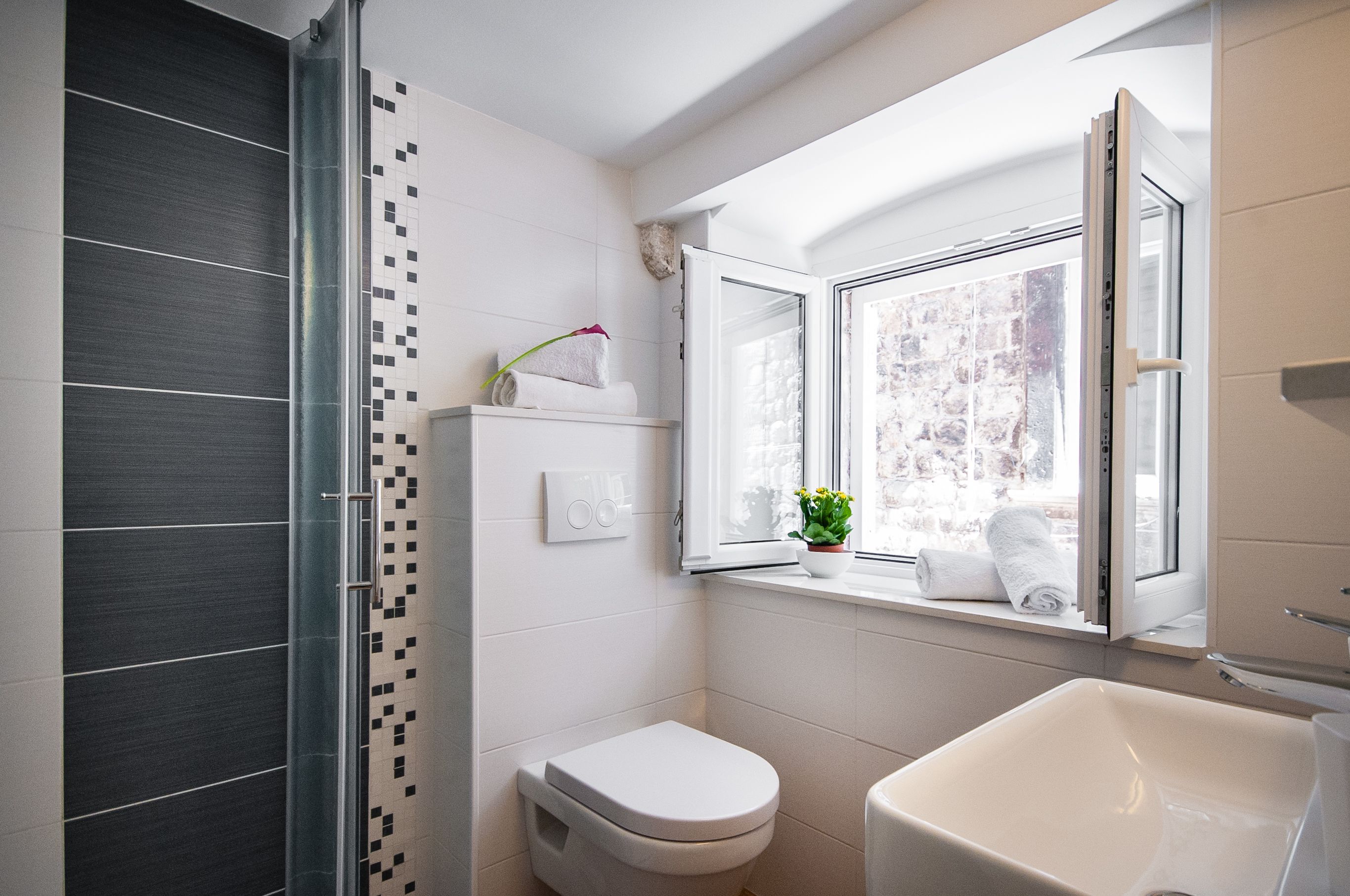 A modern bathroom with a shower, toilet, and bathtub.