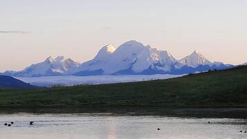 A mountain range with a lake in the foreground.