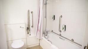 A bathroom with a toilet, a shower with grab bars, and a bathtub with a handheld showerhead. - Premier Inn Manchester Airport - M56/J6 Runger Lane North (Manchester)