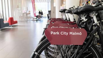 A row of bicycles with a sign that reads "Park City Malmö".