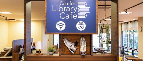 A library cafe with a sign indicating Wi-Fi and power outlets.